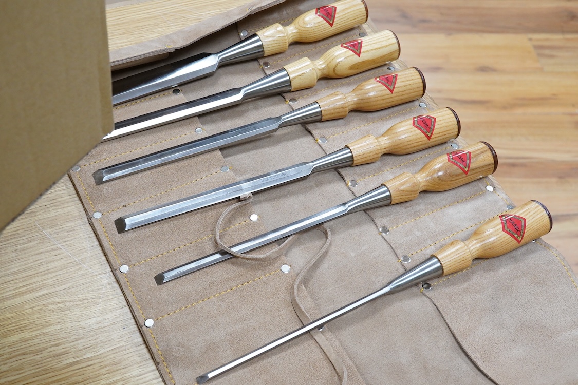Five woodworking chisel sets, all in leather rolls, including an unused nine piece set by Robert Sorby, a six piece set by Henry Taylor, and three other sets showing some wear